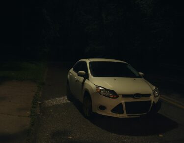 Late-night car accident scene outside author's house.